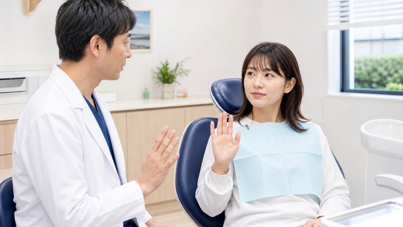 診療椅子で患者が手を上げて休憩の合図を伝える様子